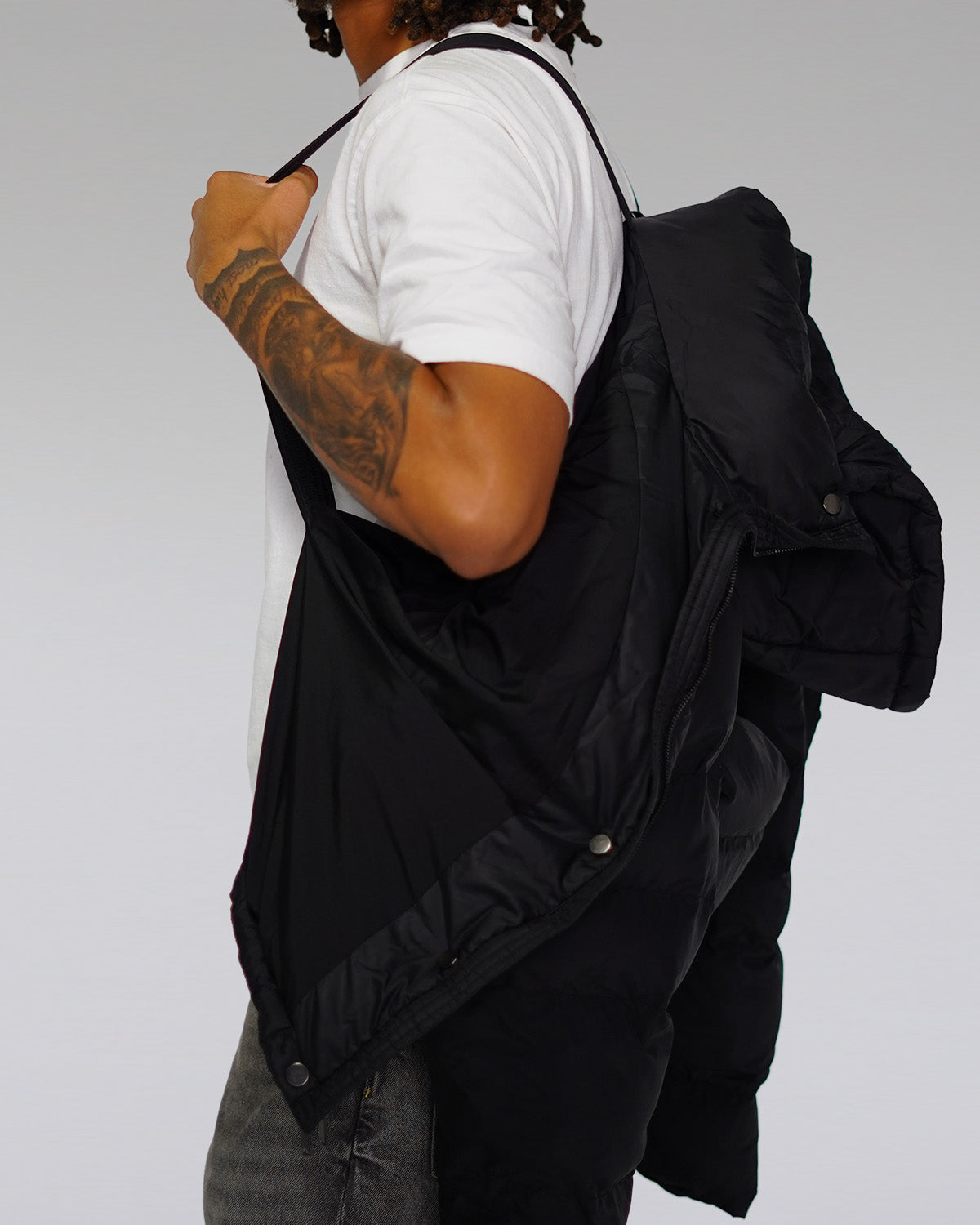 Black puffer jacket with built-in backpack straps