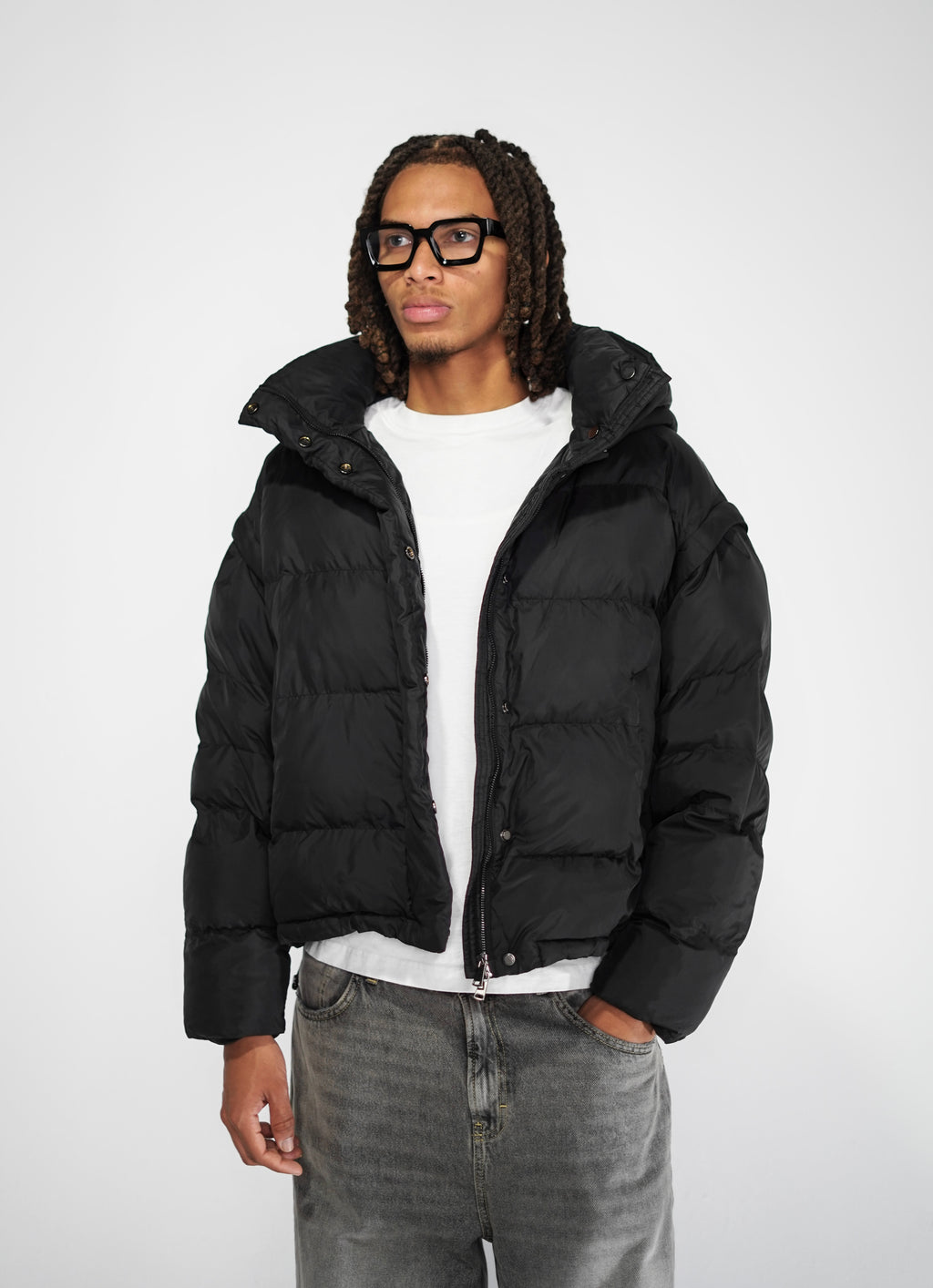 A model  wears Black streetwear puffer jacket outfit